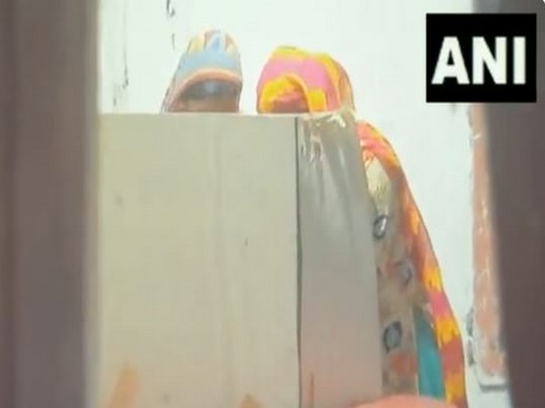 A woman assists another in a voting cublicle during West Bengal Panchayat repolls (Photo/ANI)