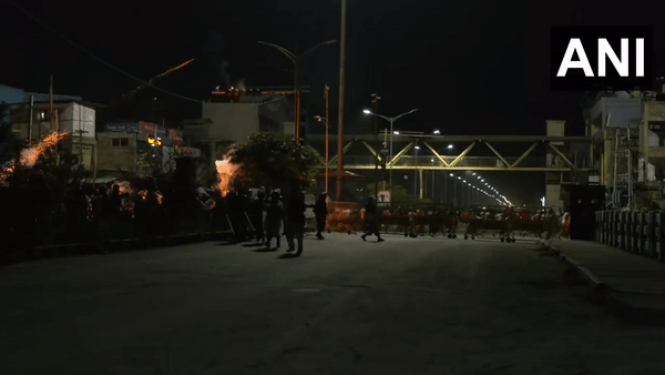 Police used several rounds of tear gas shells to stop and disperse crowd gathered near BJP office in Imphal. (Photo/ANI)